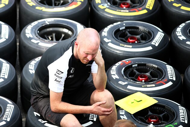 MONZA, ITALY - SEPTEMBER 03:  Members of the McLaren team speak in the paddock next to sets of Pirelli tyres during previews to the Formula One Grand Prix of Italy at Autodromo di Monza on September 3, 2015 in Monza, Italy.  (Photo by Mark Thompson/Getty Images)