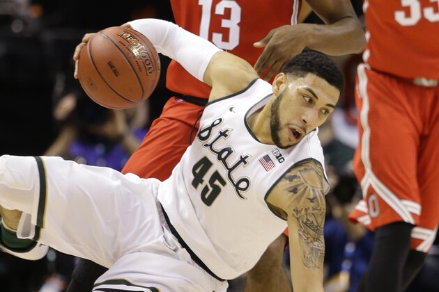 Michigan State's Denzel Valentine (45) falls as he drive against Ohio State during the first half of an NCAA college basketball game in the quarterfinals at the Big Ten Conference tournament, Friday, March 11, 2016, in Indianapolis. AP Photo/Michael Conroy)