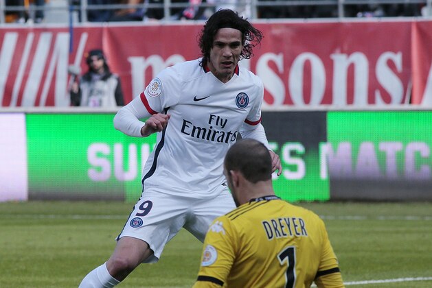 Paris Saint-Germain's Uruguayan forward Edinson Roberto Cavani (L) scores in front of Troyes' French goalkeeper Matthieu Dreyer during the French Ligue 1 football match between Troyes and Paris Saint-Germain on March 13, 2016 at the Aube Stadium in Troyes. / AFP / JACQUES DEMARTHON        (Photo credit should read JACQUES DEMARTHON/AFP/Getty Images)