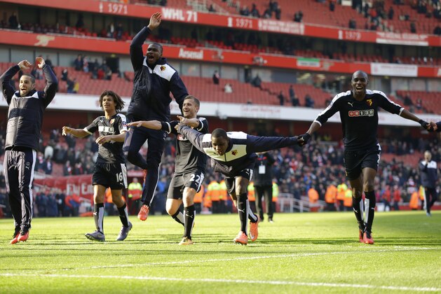 Watford players including their first goal scorer Odion Ighalo, second right, celebrate towards their fans after winning the English FA Cup quarterfinal soccer match between Arsenal and Watford 2-1 at the Emirates stadium in London, Sunday, March 13, 2016.  (AP Photo/Matt Dunham)