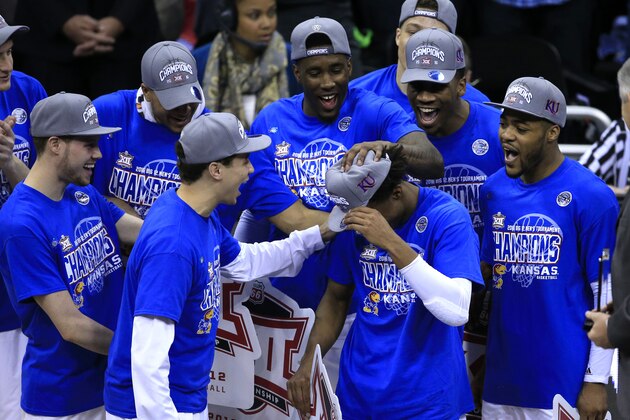 Kansas guard Devonte' Graham (4) is congratulated by teammate following an NCAA college basketball game against West Virginia in the finals of the Big 12 conference tournament in Kansas City, Mo., Saturday, March 12, 2016. Graham was named tournament MVP. Kansas defeated West Virginia 81-71. (AP Photo/Orlin Wagner)