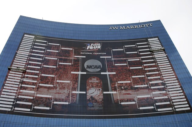 FILE- In this March 16, 2015, file photo, workers add team names to a 2015 NCAA Division I men's basketball tournament bracket that is displayed on the side of the JW Marriott in Indianapolis. With the Final Four a week away from shining a spotlight on Indianapolis, NCAA President Mark Emmert said Thursday, March 26, that the governing body for college sports is concerned about an Indiana law that could allow businesses to discriminate against gay people. (AP Photo/Darron Cummings, File)