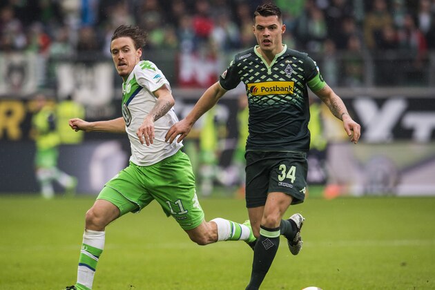 Wolfsburg's striker Max Kruse (L) and Moenchengladbach's Swiss midfielder Granit Xhaka  (R) vie for the ball during the German first division Bundesliga football match of VfL Wolfsburg v Borussia Moenchengladbach in Wolfsburg, on March 5, 2016. / AFP / ODD ANDERSEN / RESTRICTIONS: DURING MATCH TIME: DFL RULES TO LIMIT THE ONLINE USAGE TO 15 PICTURES PER MATCH AND FORBID IMAGE SEQUENCES TO SIMULATE VIDEO. == RESTRICTED TO EDITORIAL USE == FOR FURTHER QUERIES PLEASE CONTACT DFL DIRECTLY AT + 49 69 650050
        (Photo credit should read ODD ANDERSEN/AFP/Getty Images)