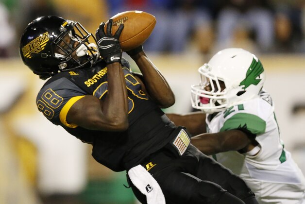 Southern Mississippi wide receiver Michael Thomas (88) pulls in a pass reception over the defense of North Texas defensive back James Gray (21) in the second half of an NCAA college football game in Hattiesburg, Miss., Saturday, Oct. 3, 2015. Southern Mississippi won 49-14. (AP Photo/Rogelio V. Solis)