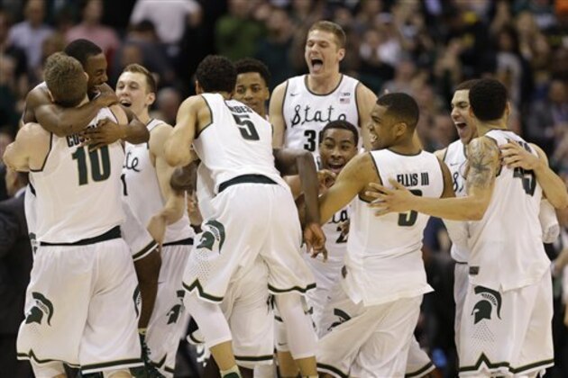 Michigan State players celebrate after an NCAA college basketball game against Purdue in the finals at the Big Ten Conference tournament, Sunday, March 13, 2016, in Indianapolis. Michigan State won 66-62. (AP Photo/Michael Conroy)