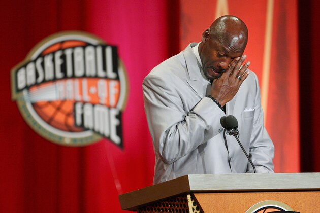 Former Chicago Bulls and Washington Wizards guard Michael Jordan wipes tears from his eyes as he prepares to deliver his address during his enshrinement ceremony into the Naismith Basketball Hall of Fame in Springfield, Mass., Friday, Sept. 11, 2009. (AP Photo/Stephan Savoia)