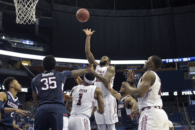 Temple forward Jaylen Bond (15), center, puts up a shot in front of Connecticut center Amida Brimah (35) during the second half of an NCAA college basketball game in the semifinals of the American Athletic Conference men's tournament in Orlando, Fla., Saturday, March 12, 2016. Connecticut won 77-62. (AP Photo/Phelan M. Ebenhack)