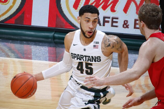 Michigan State's Denzel Valentine (45) drives against Ohio State's Mickey Mitchell during the first half of an NCAA college basketball game, Saturday, March 5, 2016, in East Lansing, Mich. (AP Photo/Al Goldis)