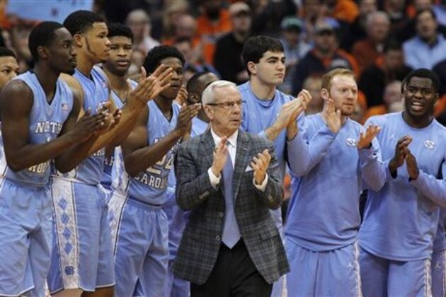FILE - In this Jan. 9, 2016, file photo, North Carolina head coach Roy Williams claps with players on the bench during the second half of an NCAA college basketball game against Syracuse in Syracuse, N.Y. No. 2 North Carolina is the only unbeaten team in the Atlantic Coast Conference after a favorable opening month of the league schedule. The Tar Heels on Saturday play Boston College, which is 0-7 in the league. Then things get tougher.  (AP Photo/Nick Lisi, File)