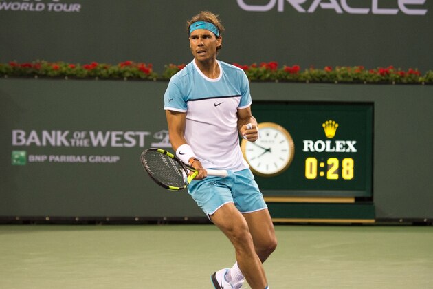 Rafel Nadal of Spain returns a shot to Gilles Muller of Luxembourg during second round play at the BNP Paribas Open at the Indian Wells Tennis Garden on March 13, 2016, in Indian Wells, California. / AFP / ROBYN BECK        (Photo credit should read ROBYN BECK/AFP/Getty Images)