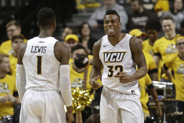 Virginia Commonwealth's Melvin Johnson (32) celebrates with teammate JeQuan Lewis (1) during the second half of an NCAA college basketball game during the Atlantic 10 men's tournament against Massachusetts Friday, March 11, 2016, in New York. Virginia Commonwealth won 85-70. (AP Photo/Frank Franklin II)