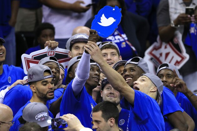 The Kansas Jayhawks pose for a team photo after winning an NCAA college basketball game against West Virginia in the finals of the Big 12 conference tournament in Kansas City, Mo., Saturday, March 12, 2016. (AP Photo/Orlin Wagner)
