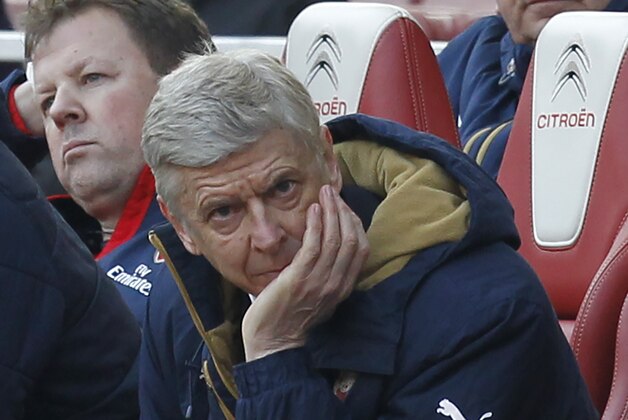 Arsenal's French manager Arsene Wenger reacts in his seat as his team try to come back from two goals down in the FA Cup quarter final football match between Arsenal and Watford at the Emirates Stadium in London on March 13, 2016.  / AFP / Ian Kington / RESTRICTED TO EDITORIAL USE. No use with unauthorized audio, video, data, fixture lists, club/league logos or 'live' services. Online in-match use limited to 75 images, no video emulation. No use in betting, games or single club/league/player publications.  /         (Photo credit should read IAN KINGTON/AFP/Getty Images)