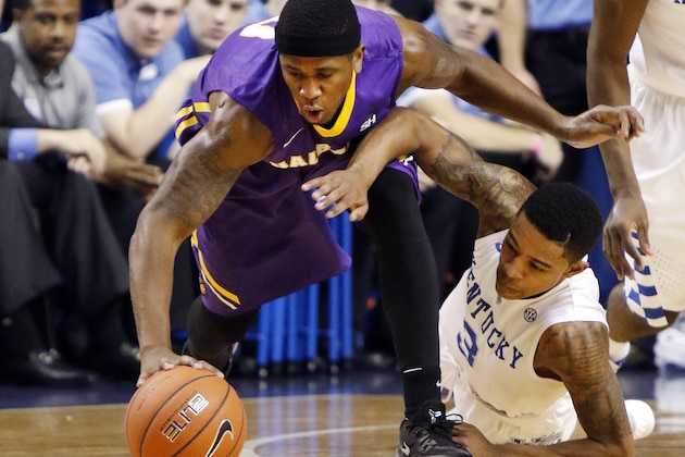 Albany's Evan Singletary, left, and Kentucky's Tyler Ulis chase down the ball during an NCAA college basketball game Friday, Nov. 13, 2015, in Lexington, Ky. (AP Photo/James Crisp)