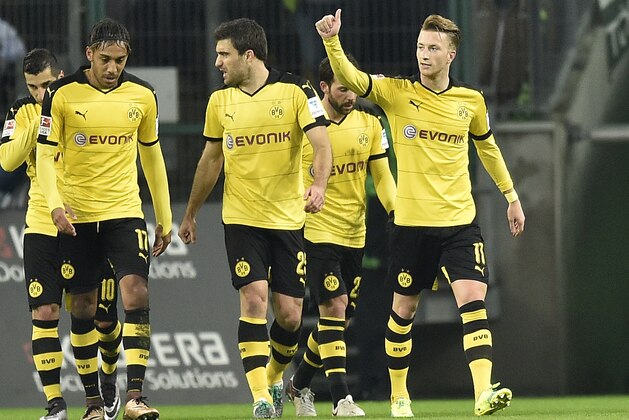 Dortmund's Marco Reus, right, celebrates his opening goal during the German Bundesliga soccer match between Borussia Moenchengladbach and Borussia Dortmund in Moenchengladbach, Germany, Saturday, Jan. 23, 2016. (AP Photo/Martin Meissner)