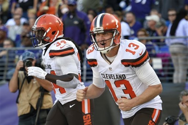 FILE - In this Oct. 11, 2015, file photo, Cleveland Browns quarterback Josh McCown, right, and running back Isaiah Crowell celebrate McCown's touchdown pass to Crowell in the second half of an NFL football game against the Baltimore Ravens in Baltimore. With Johnny Manziel benched for bad behavior, McCown, who passed for 457 yards against Baltimore earlier this season, gets another crack at the injury-riddled Ravens. (AP Photo/Nick Wass, File)