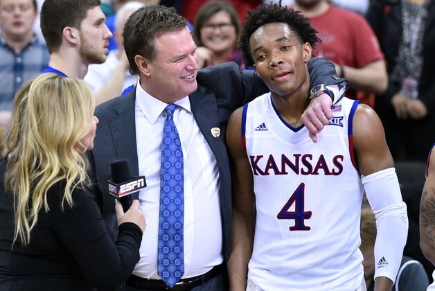 Mar 12, 2016; Kansas City, MO, USA; Kansas Jayhawks head coach Bill Self and tournament most valuable player guard Devonte' Graham (4) are interviewed after the  championship game of the Big 12 Conference tournament against the West Virginia Mountaineers at Sprint Center. Kansas Won 81-71. Mandatory Credit: Denny Medley-USA TODAY Sports