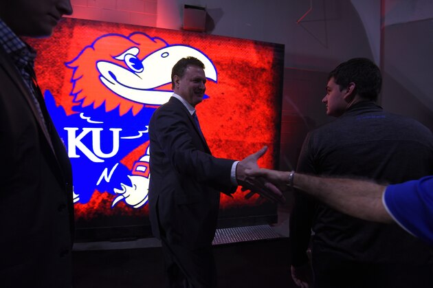 KANSAS CITY, MO - MARCH 12:  Bill Self head coach of the Kansas Jayhawks slaps a fans hand as he heads to the locker room after Kansas won the Big 12 Basketball Tournament against the West Virginia Mountaineers at Sprint Center on March 12, 2016 in Kansas City, Missouri. (Photo by Ed Zurga/Getty Images)