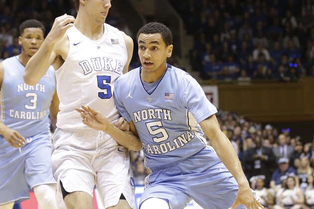 North Carolina's Marcus Paige (5) dribbles as Duke's Luke Kennard defends during the first half of an NCAA college basketball game in Durham, N.C., Saturday, March 5, 2016. (AP Photo/Gerry Broome)