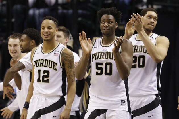 Purdue's Vince Edwards (12), Purdue's Caleb Swanigan (50) and Purdue's A.J. Hammons (20) celebrate during the second half of an NCAA college basketball game against the Illinois in the quarterfinals at the Big Ten Conference tournament, Friday, March 11, 2016, in Indianapolis. Purdue won 89-58. (AP Photo/Michael Conroy)