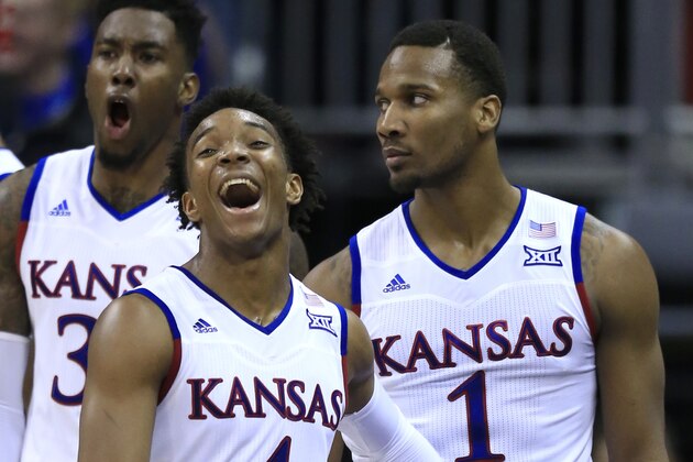 Kansas guard Devonte' Graham (4) and forward Jamari Traylor, back, celebrate a dunk by Wayne Selden Jr. (1) during the second half of an NCAA college basketball game against Baylor in the semifinals of the Big 12 conference tournament in Kansas City, Mo., Friday, March 11, 2016. Kansas defeated Baylor 70-66. (AP Photo/Orlin Wagner)