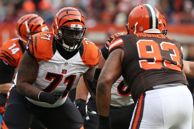 Cincinnati Bengals tackle Andre Smith (71) against the Cleveland Browns defensive end John Hughes (93) in the first half of an NFL football game, Sunday, Dec. 6, 2015, in Cleveland. (AP Photo/Ron Schwane)