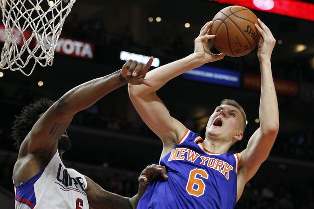 New York Knicks forward Kristaps Porzingis, left, of Latvia, shoots against Los Angeles Clippers center DeAndre Jordan, right, during the second half of an NBA basketball game in Los Angeles, Friday, March 11, 2016. The Clippers won 101-94. (AP Photo/Alex Gallardo)