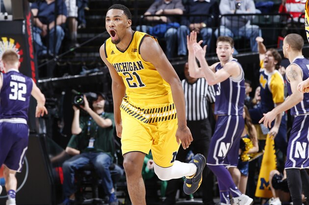 INDIANAPOLIS, IN - MARCH 10: Zak Irvin #21 of the Michigan Wolverines celebrates hitting the game-winning shot against the Northwestern Wildcats in the second round of the Big Ten Basketball Tournament at Bankers Life Fieldhouse on March 10, 2016 in Indianapolis, Indiana. Michigan defeated Northwestern 72-70 in overtime. (Photo by Joe Robbins/Getty Images)