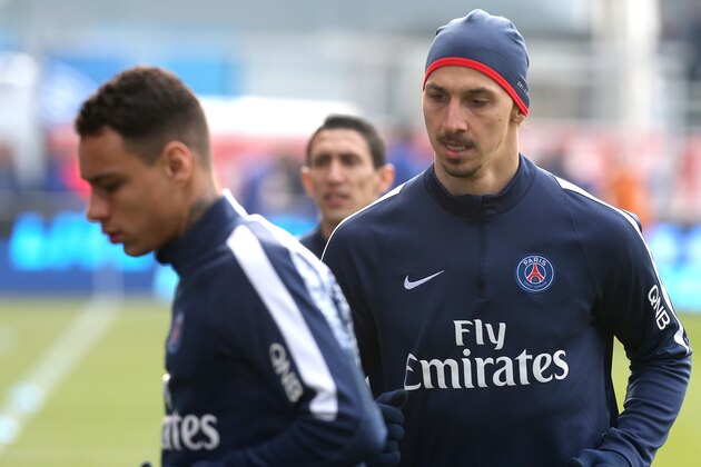 Paris Saint-Germain's Swedish forward Zlatan Ibrahimovic (R) and Paris Saint-Germain's Dutch defender Gregory van der Wiel (L) warm up prior to the French Ligue 1 football match between Troyes and Paris Saint-Germain on March 13, 2016 at the Aube Stadium in Troyes. AFP PHOTO  / FRANCOIS NASCIMBENI / AFP / FRANCOIS NASCIMBENI        (Photo credit should read FRANCOIS NASCIMBENI/AFP/Getty Images)