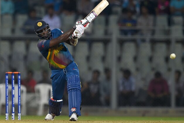 Sri Lanka's Angelo Mathews plays a shot during a warm up World T20 cricket tournament match between New Zealand and Sri Lanka at The Wankhede Cricket Stadium in Mumbai on March 10, 2016.  / AFP / INDRANIL MUKHERJEE        (Photo credit should read INDRANIL MUKHERJEE/AFP/Getty Images)