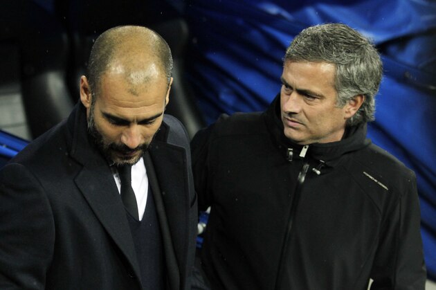 Real Madrid's coach Jose Mourinho from Portugal, left,  shakes hand with FC Barcelona's coach Pep Guardiola, right, during their Spanish La Liga soccer match at the Santiago Bernabeu stadium in Madrid, Spain, Saturday, Dec. 10, 2011. (AP Photo/Andres Kudacki)
