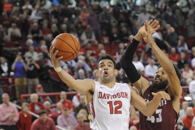 Feb 20, 2016; Davidson, NC, USA; Davidson Wildcats guard Jack Gibbs (12) drives to the basket as he is defended by St. Joesph Hawks forward DeAndre' Bembry (43) during the second half of the game at Belk Arena. Wildcats win 99-93. Mandatory Credit: Sam Sharpe-USA TODAY Sports