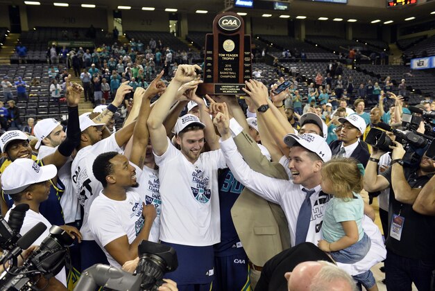 Mar 7, 2016; Baltimore, MD, USA;  North Carolina-Wilmington Seahawks celebrate as the hoist the trophy  on the court after defeating Hofstra Pride 80-73 for the a CAA conference tournament championship at Royal Farms Arena. Mandatory Credit: Tommy Gilligan-USA TODAY Sports