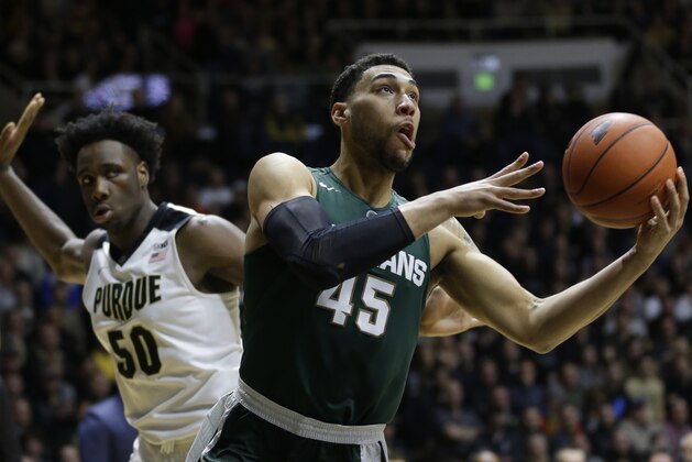 Michigan State guard Denzel Valentine (45) shoots in front of Purdue forward Caleb Swanigan (50) in the first half of an NCAA college basketball game in West Lafayette, Ind., Tuesday, Feb. 9, 2016. (AP Photo/Michael Conroy)