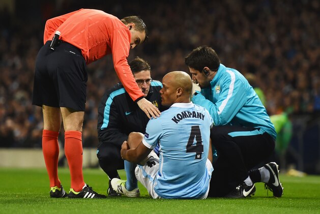 MANCHESTER, ENGLAND - MARCH 15:  An injured Vincent Kompany of Manchester City (4) is given treatment during the UEFA Champions League round of 16 second leg match between Manchester City FC and FC Dynamo Kyiv at the Etihad Stadium on March 15, 2016 in Manchester, United Kingdom.  (Photo by Laurence Griffiths/Getty Images)