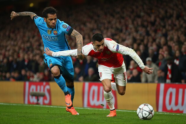 LONDON, ENGLAND - FEBRUARY 23: Alexis Sanchez of Arsenal takes on Dani Alves of Barcelona  during the UEFA Champions League round of 16 first leg match between Arsenal and Barcelona on February 23, 2016 in London, United Kingdom.  (Photo by Paul Gilham/Getty Images)