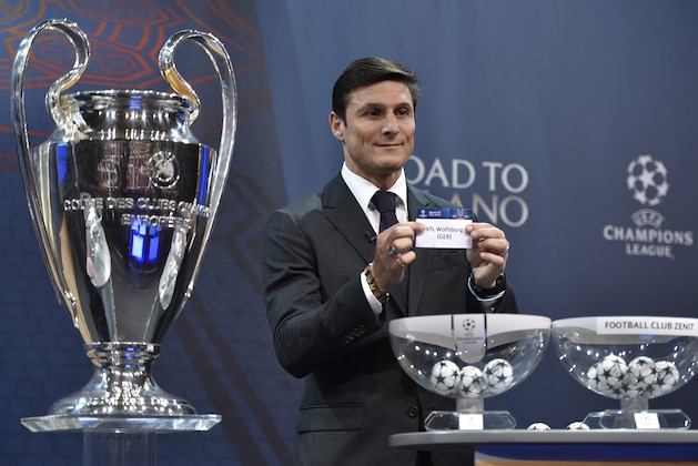 UEFA Champions League final ambassador  Javier Zanetti shows the name of Wolfsburg during the draw for the UEFA Champions league round of sixteen, on December 14, 2015 at the European football organization's headquarters in Nyon.  AFP PHOTO / FABRICE COFFRINI / AFP / FABRICE COFFRINI        (Photo credit should read FABRICE COFFRINI/AFP/Getty Images)