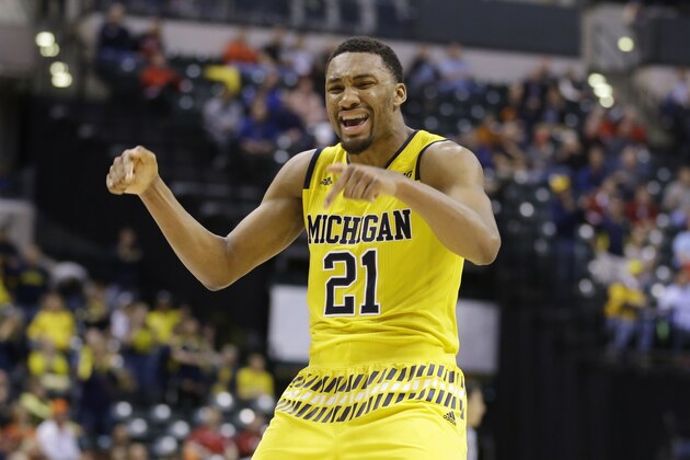 Michigan's Zak Irvin (21) celebrates after scoring a game winning basket during the overtime of an NCAA college basketball game  against Northwestern at the Big Ten Conference tournament, Thursday, March 10, 2016, in Indianapolis. Michigan won 72-70. (AP Photo/Michael Conroy)