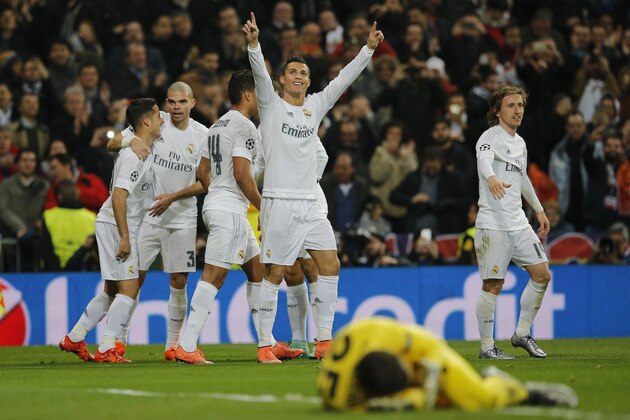 Real Madrid's Cristiano Ronaldo, center, celebrates after scoring the opening goal during the Champions League Round of 16, second leg soccer match between Real Madrid and Roma at the Santiago Bernabeu stadium in Madrid, Tuesday March 8, 2016. (AP Photo/Paul White)