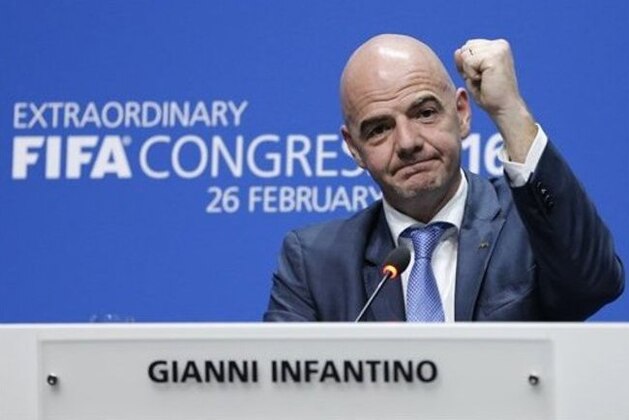 FILE - This is a Friday, Feb. 26, 2016  file photo of  the newly elected FIFA president Gianni Infantino of Switzerland as he raises an arm during a press conference after the second election round during the extraordinary FIFA congress in Zurich, Switzerland.  While acknowledging for the first time that votes were bought in past World Cup hosting contests, FIFA is seeking to claim