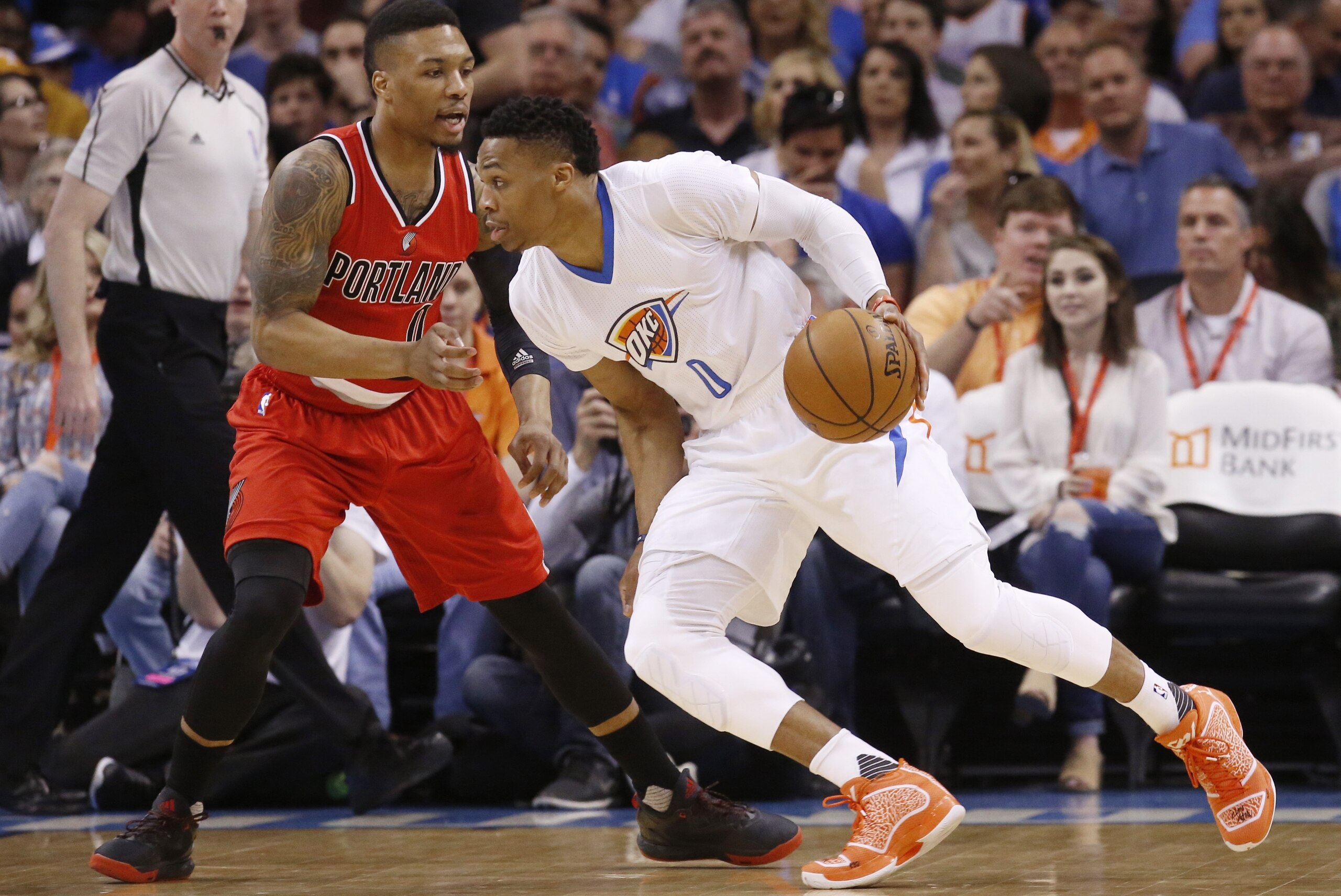 Oklahoma City Thunder guard Russell Westbrook (0) drives around Portland Trail Blazers guard Damian Lillard, left, in the first quarter of an NBA basketball game in Oklahoma City, Monday, March 14, 2016. (AP Photo/Sue Ogrocki)