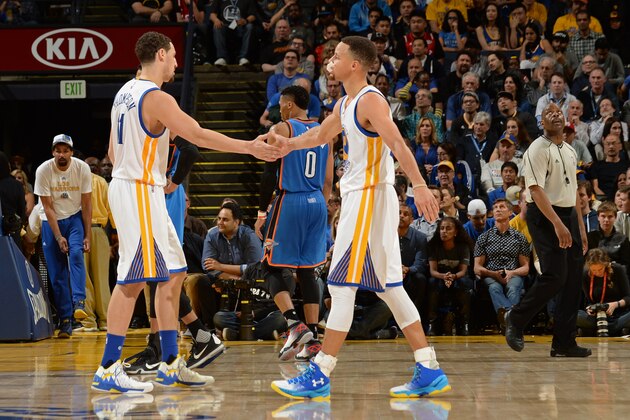OAKLAND, CA - MARCH 3:  Klay Thompson #11 and Stephen Curry #30 of the Golden State Warriors shake hands against the Oklahoma City Thunder on March 3, 2016 at ORACLE Arena in Oakland, California. NOTE TO USER: User expressly acknowledges and agrees that, by downloading and or using this photograph, user is consenting to the terms and conditions of Getty Images License Agreement. Mandatory Copyright Notice: Copyright 2016 NBAE (Photo by Noah Graham/NBAE via Getty Images)