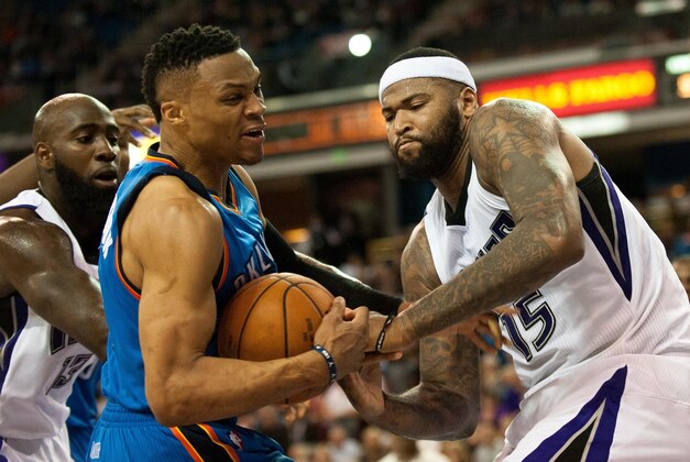 Feb 29, 2016; Sacramento, CA, USA; Oklahoma City Thunder guard Russell Westbrook (0) and Sacramento Kings center DeMarcus Cousins (15) fight for possession of the ball during the fourth quarter at Sleep Train Arena. The Thunder defeated the Kings 131-116. Mandatory Credit: Ed Szczepanski-USA TODAY Sports