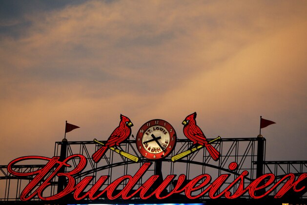 The St. Louis Cardinals birds on a bat logo is seen along with a Budweiser advertisement on a scoreboard at Busch Stadium during a baseball game between the St. Louis Cardinals and Milwaukee Brewers Tuesday, July 22, 2008, in St. Louis. (AP Photo/Jeff Roberson)