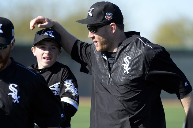 GLENDALE, ARIZONA - FEBRUARY 24:  Todd Frazier #21 of the Chicago White Sox jokes around with Drake LaRoche, Adam LaRoche's son during spring training workouts on February 24, 2015 at Camelback Ranch in Glendale Arizona.  (Photo by Ron Vesely/MLB Photos via Getty Images)