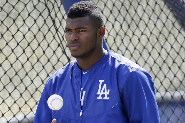 Los Angeles Dodgers' Yasiel Puig tosses a ball during practice for the upcoming NLDS playoff baseball series against the New York Mets, Tuesday, Oct. 6, 2015, in Los Angeles. Their NLDS best of five playoff series begins Friday, Oct. 9, at Dodger Stadium. (AP Photo/Danny Moloshok)