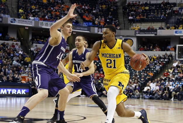 Mar 10, 2016; Indianapolis, IN, USA; Michigan Wolverines guard Zak Irvin (21) drives to the basket against Northwestern Wildcats forward Gavin Skelly (44) during the Big Ten Conference tournament at Bankers Life Fieldhouse. Michigan defeats Northwestern 72-70 in overtime. Mandatory Credit: Brian Spurlock-USA TODAY Sports
