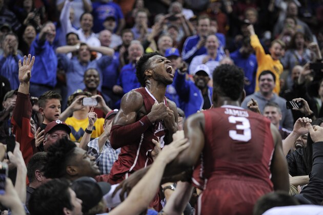 KANSAS CITY, MO - MARCH 11: Buddy Hield #24 of the Oklahoma Sooners celebrates with fans after he thought he made the game-winning basket against the West Virginia Mountaineers during the semifinals of the Big 12 Basketball Tournament at Sprint Center on March 11, 2016 in Kansas City, Missouri. After review the shot was overturn and West Virginia won 69-67. (Photo by Ed Zurga/Getty Images)