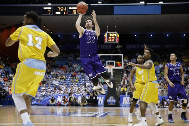 Holy Cross' Robert Champion (22) shoots over Southern University's Jared Sam (12) as Holy Cross' Eric Green (24) and Southern's Trelun Banks, second from right, and Christopher Hyder, third from right, watch during the first half of a First Four game of the NCAA college basketball tournament, Wednesday, March 16, 2016, in Dayton, Ohio. (AP Photo/John Minchillo)
