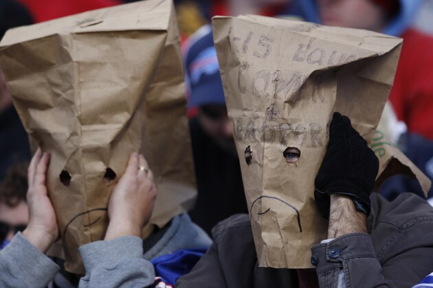 Unhappy fans wear bags as the Buffalo Bills play the Cleveland Browns during the first half of the NFL football game in Orchard Park, N.Y., Sunday Oct. 11, 2009. (AP Photo/David Duprey)